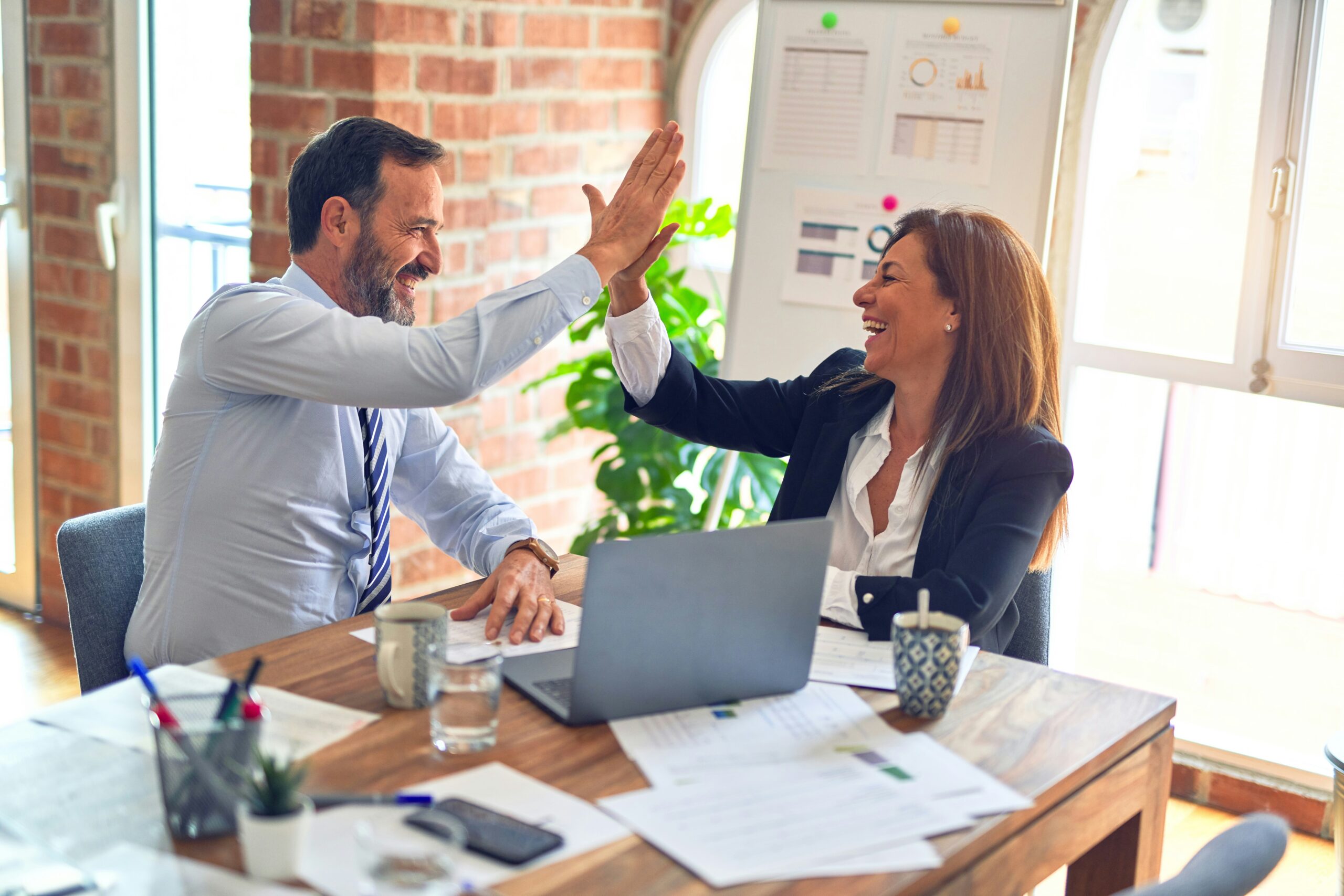 woman-and-a-man-high-five-celebrating